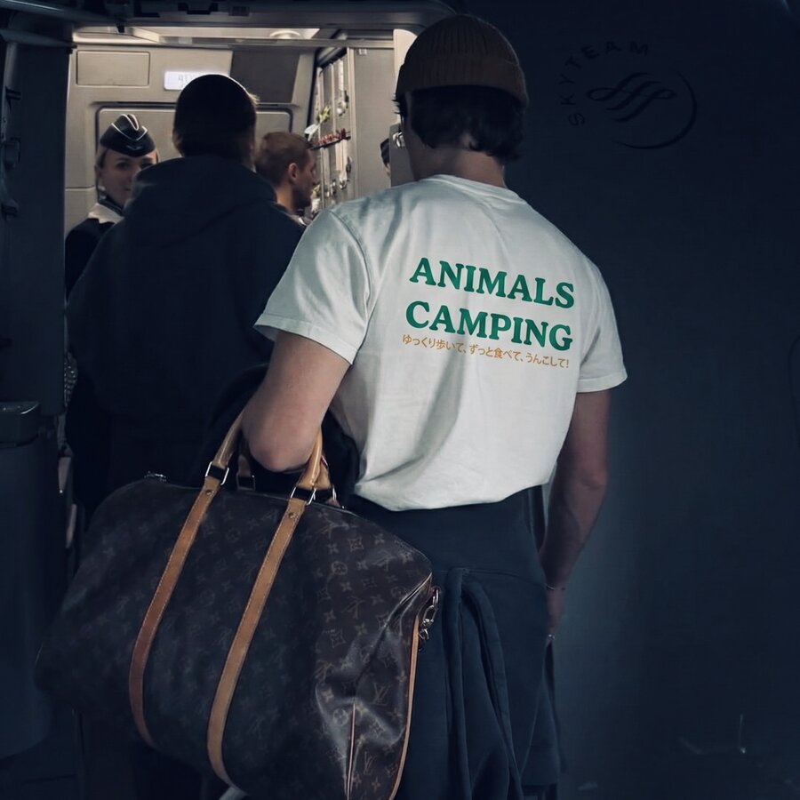 Animals Camping tee worn at the airport, with Japanese text on back