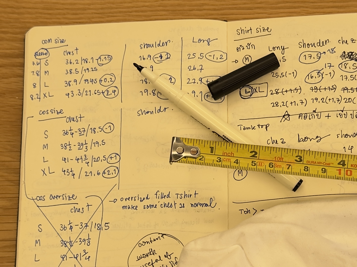 Hand-written research notebook from the Animal de Compagnie design process — competitor measurements, hem lengths, and shoulder grading by hand